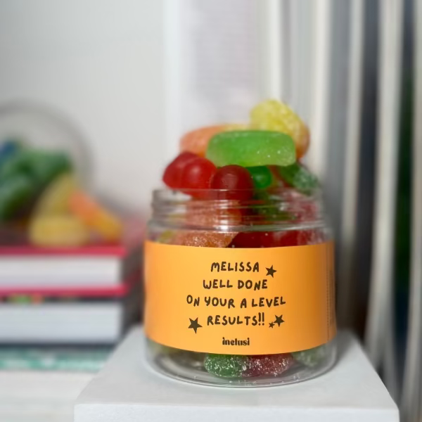 An inclusi vegan and gluten free gummies jar with a personalised well done on your A level results message on to gift