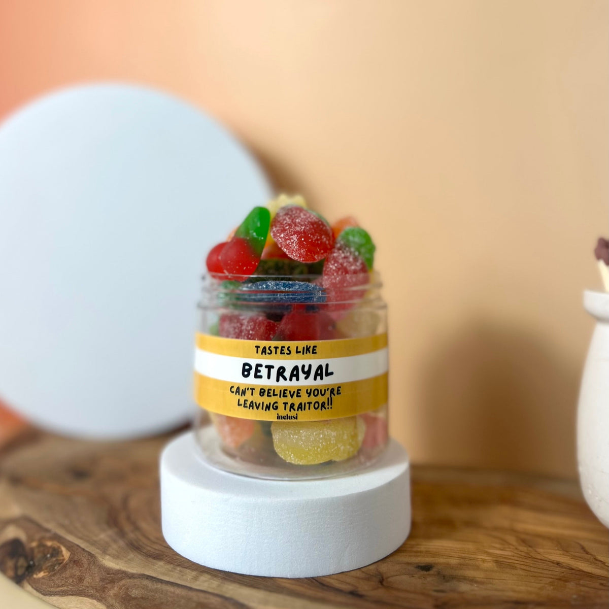 Jar of colourful vegan and gluten free sweets with funny leaving gift for colleagues