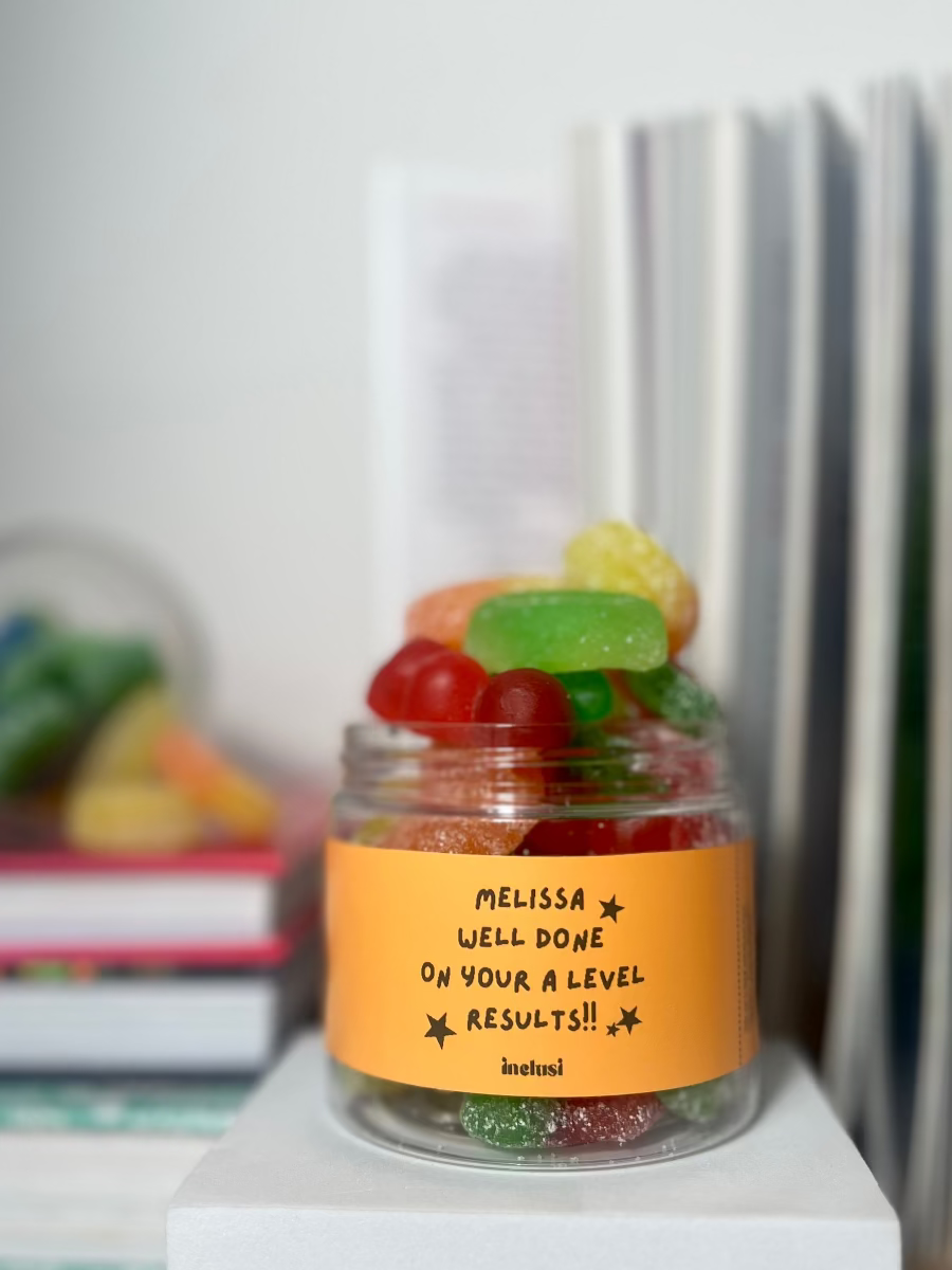 An inclusi vegan and gluten free gummies jar with a personalised well done on your A level results message on to gift 