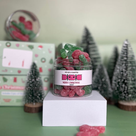 Jar of vegan and gluten free candy canes with christmas cracker slogan