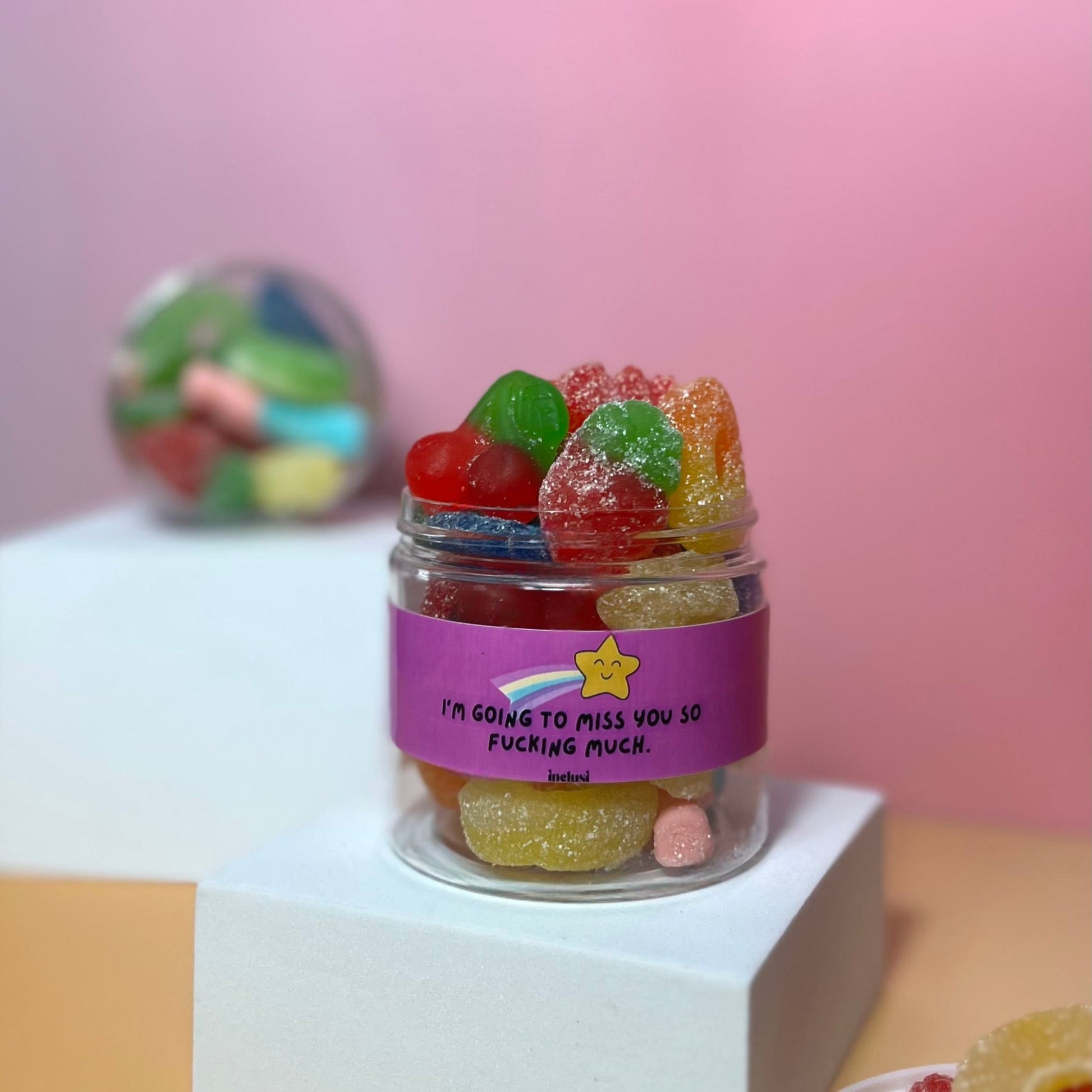 Jar of colourful vegan, gluten free sweets with miss you message on front