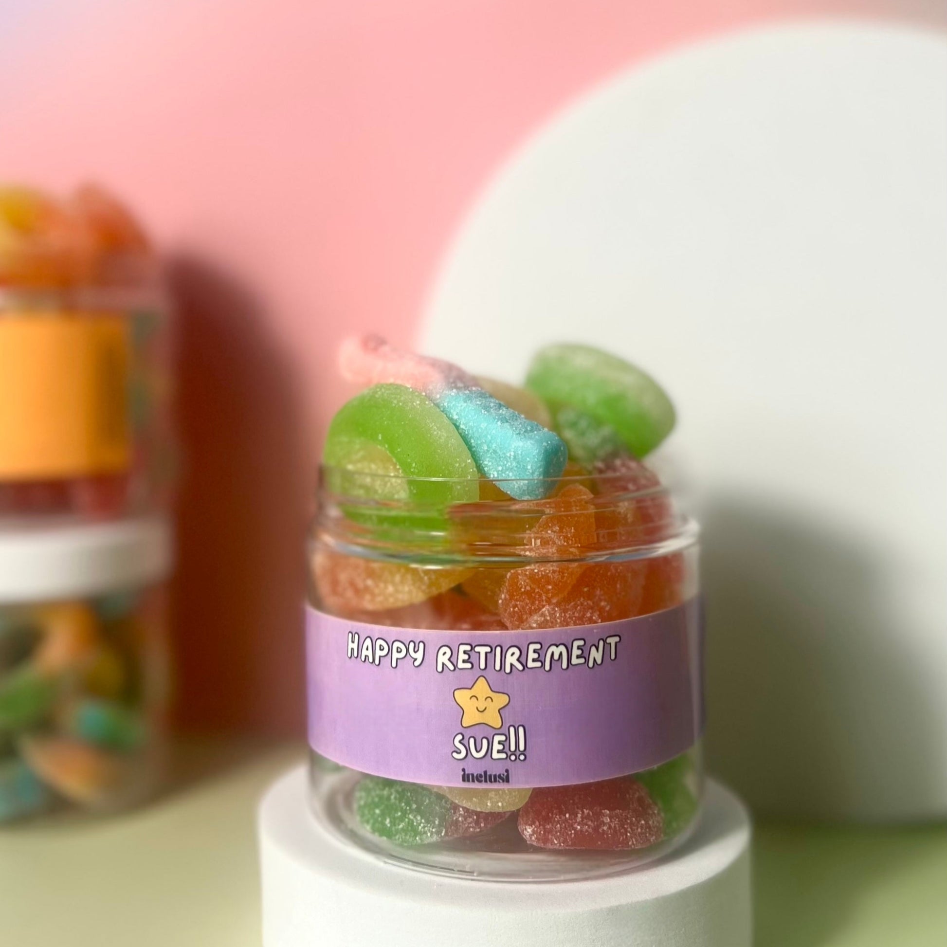 A jar of colourful vegan and gluten free sweets with personalised happy retirement message